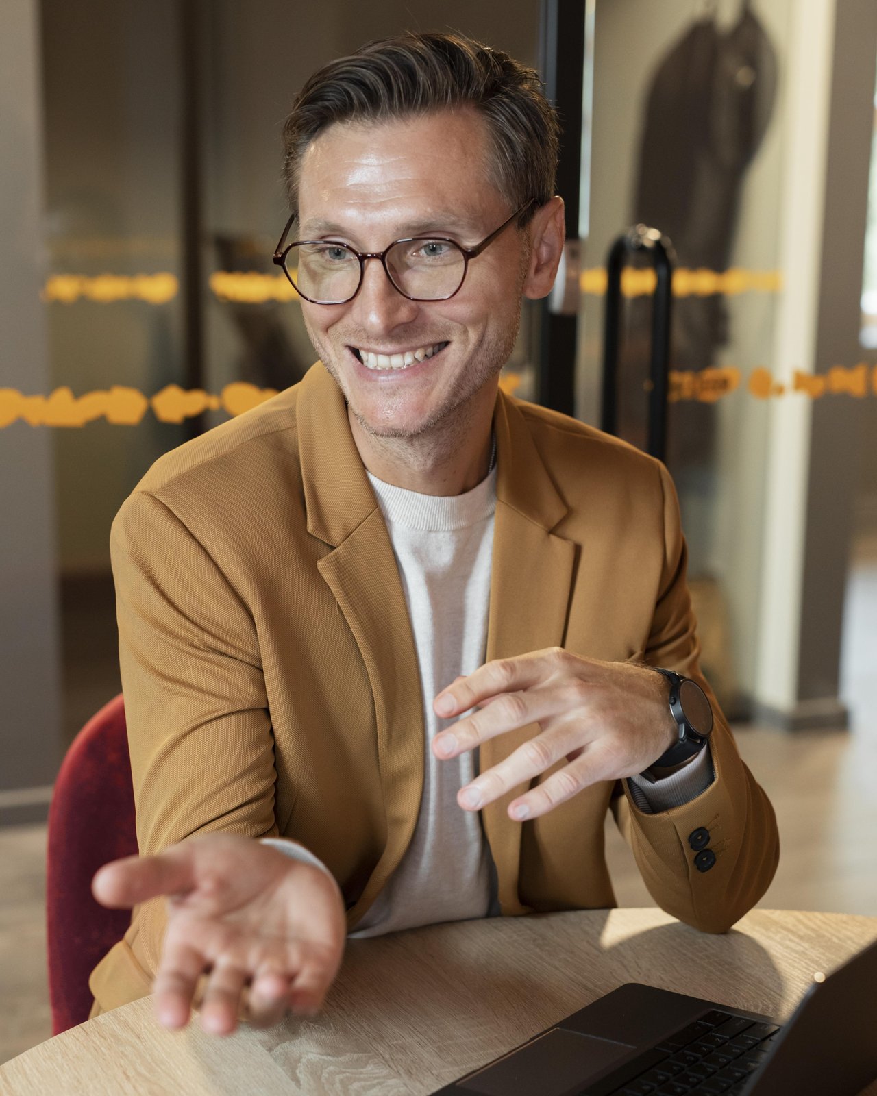 Satisfied American business owner mid-conversation at his desk